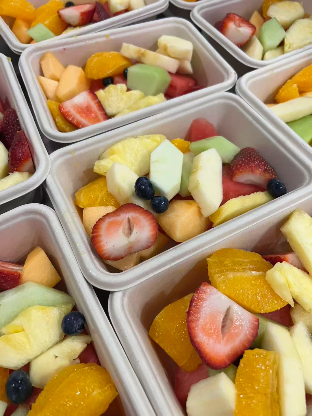 A close view of VC Yogurt fresh-cut fruit in individual fruit boxes.